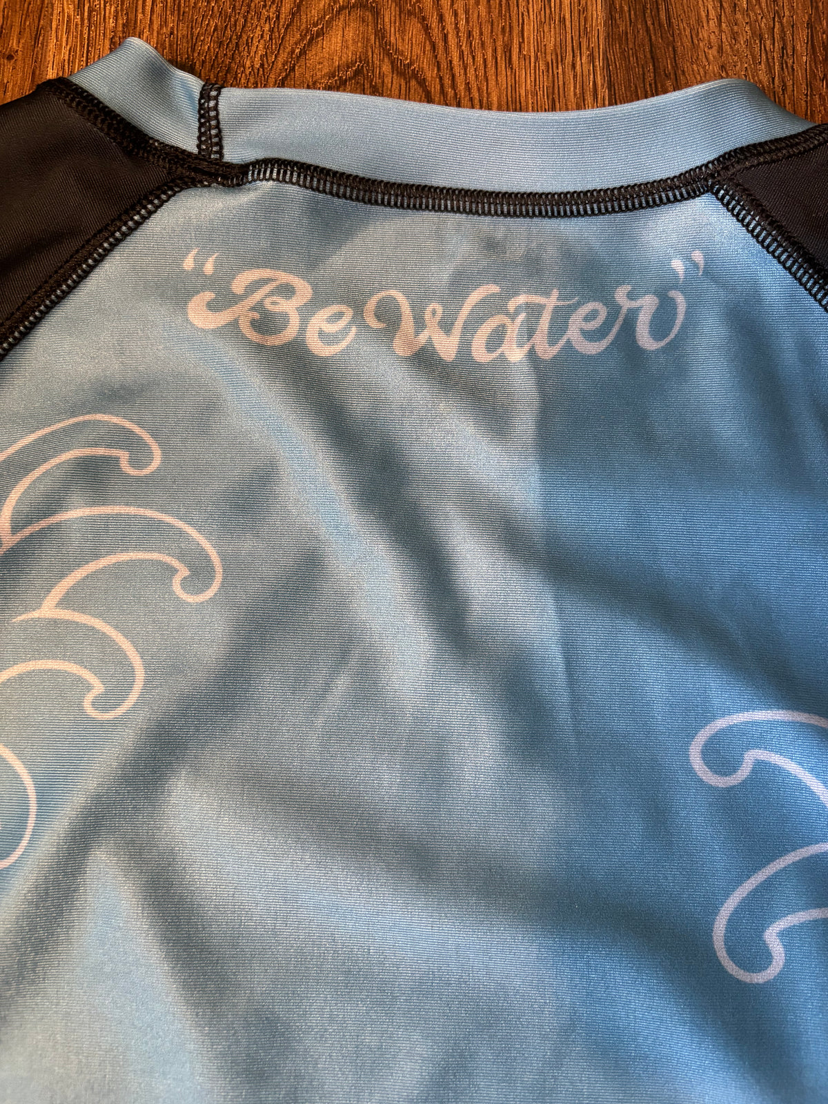 Be Water  Rash Guard